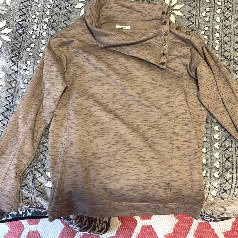 Purple long sleeve shirt with buttons up the one shoulder.